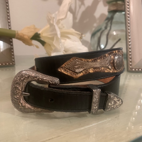 Accessories - Leather belt with snake skin and silver buckle and medallion details.